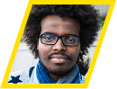 Portrait of a man with glasses and curly hair wearing a blue scarf.