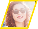Smiling woman wearing sunglasses in bright sunlight.